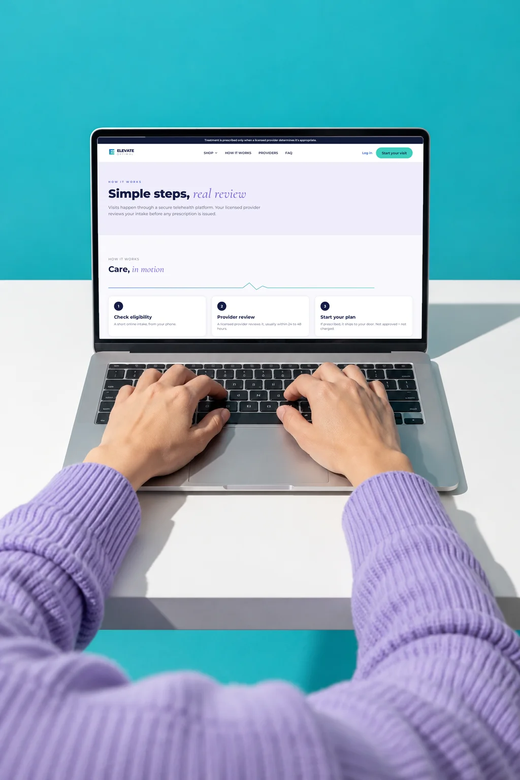 Hands typing on a laptop showing the Elevate Optimal site